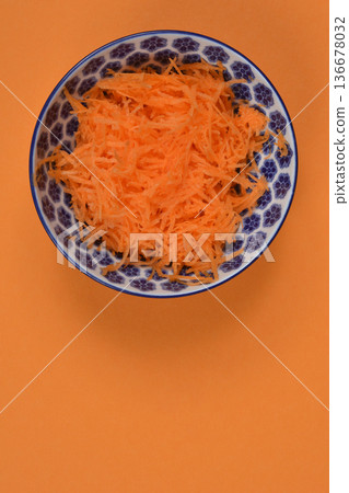 Grated Carrots in Ceramic Bowl Grated Carrots in Ceramic Bowl 136678032