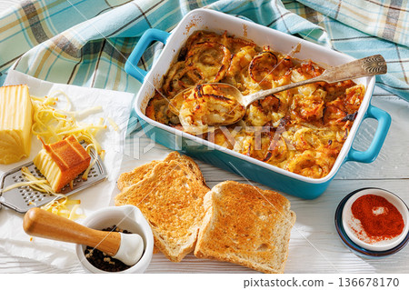 southern onion casserole with cheese and toast 136678170