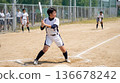 Female softball team member standing in the batter's box 136678242