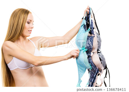 Woman holds bras, choosing Woman holds bras, choosing 136678411