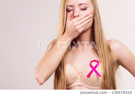 Woman pink cancer ribbon on breast Woman pink cancer ribbon on breast 136678428