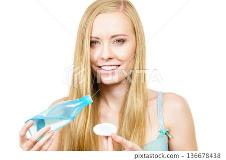Woman using cleanser cosmetic Woman using cleanser cosmetic 136678438