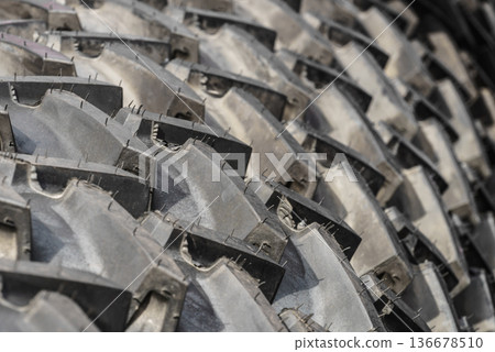 Detailed closeup of rubber tire wheel surface. 136678510