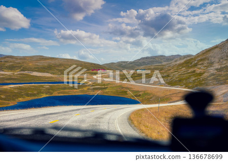 Driving a car in the tundra in summer. Arctic lakes. View from the windshield. Wildlife of Norway. North Cape, Mageroya Island Driving a car in the tundra in summer. Arctic lakes. View from the windshield. Wildlife of Norway. North Cape, Mageroya Island 136678699