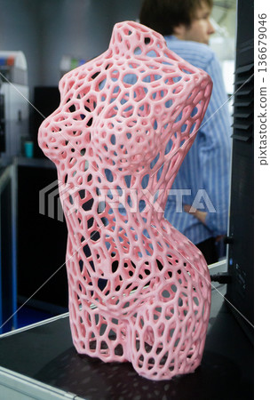 Form printed on 3D printer from plastic. Sculpture of a female torso made using 3D printing from filament. Additive manufacturing. Layer-by-layer application of material. 3D printing FDM technologies Form printed on 3D printer from plastic. Sculpture of a female torso made using 3D printing from filament. Additive manufacturing. Layer-by-layer application of material. 3D printing FDM technologies 136679046