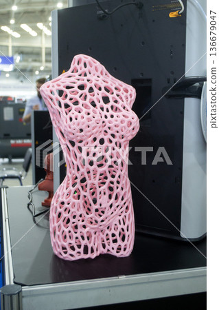 Form printed on 3D printer from plastic. Sculpture of a female torso made using 3D printing from filament. Additive manufacturing. Layer-by-layer application of material. 3D printing FDM technologies Form printed on 3D printer from plastic. Sculpture of a female torso made using 3D printing from filament. Additive manufacturing. Layer-by-layer application of material. 3D printing FDM technologies 136679047