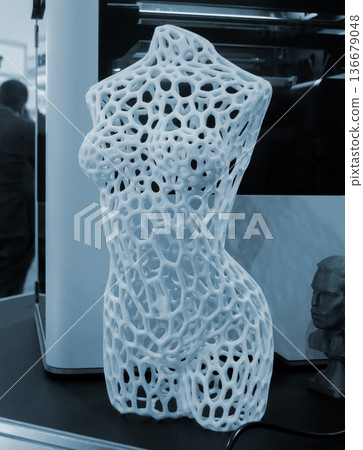 Form printed on 3D printer from plastic. Sculpture of a female torso made using 3D printing from filament. Additive manufacturing. Layer-by-layer application of material. 3D printing FDM technologies Form printed on 3D printer from plastic. Sculpture of a female torso made using 3D printing from filament. Additive manufacturing. Layer-by-layer application of material. 3D printing FDM technologies 136679048