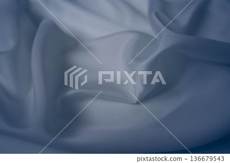 White and cashmere blue silk fabric with elegant flowing folds White and cashmere blue silk fabric with elegant flowing folds 136679543