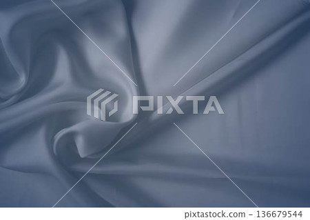 White and cashmere blue silk fabric with elegant flowing folds White and cashmere blue silk fabric with elegant flowing folds 136679544