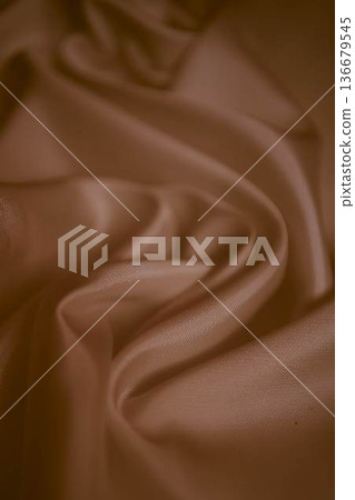Elegant dusty rose silk fabric with soft flowing folds Elegant dusty rose silk fabric with soft flowing folds 136679545