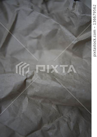 Crumpled brown kraft paper texture with rough fold 136679562