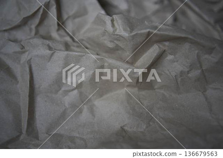 Crumpled brown kraft paper texture with rough fold Crumpled brown kraft paper texture with rough fold 136679563