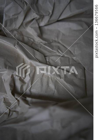 Crumpled brown kraft paper texture with rough fold 136679566