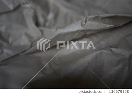 Crumpled brown kraft paper texture with rough fold 136679568