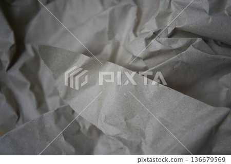 Crumpled brown kraft paper texture with rough fold Crumpled brown kraft paper texture with rough fold 136679569