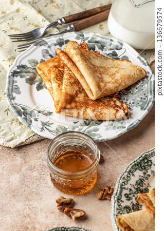 Delicious crepes folded on ceramic plate. Tasty morning breakfast on beige table background, Maslenitsa concept Delicious crepes folded on ceramic plate. Tasty morning breakfast on beige table background, Maslenitsa concept 136679574