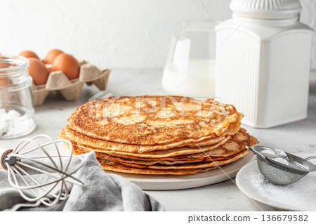 Stack of delicious crepes on light gray table background Stack of delicious crepes on light gray table background 136679582