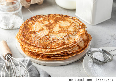 Stack of delicious crepes on light gray table background Stack of delicious crepes on light gray table background 136679585
