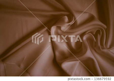 Elegant dusty rose silk fabric with soft flowing folds 136679592