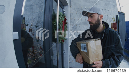 Male Courier in Uniform Delivers Cardboard Box Female Customer Male Courier in Uniform Delivers Cardboard Box Female Customer 136679689