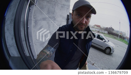 Male Courier Ringing Bell and Leaving an Order at Door Male Courier Ringing Bell and Leaving an Order at Door 136679709