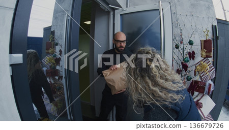 Courier With Large Delivery Backpack Arrives at House and Rings Doorbell 136679726