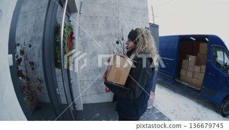 Female Courier With Headset Carries Parcel Front Door Female Courier With Headset Carries Parcel Front Door 136679745