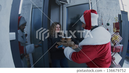 Santa Delivers Stacks of Pizza Boxes and Takeaway Coffee Cup to Young Woman Santa Delivers Stacks of Pizza Boxes and Takeaway Coffee Cup to Young Woman 136679752