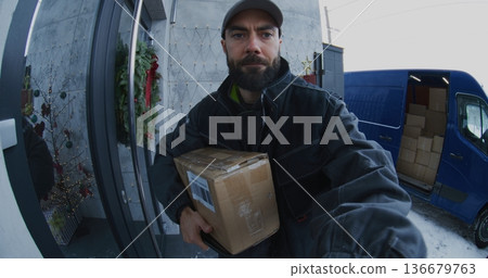 Bearded Courier Hands Over Parcel and Manages Electronic Signature Process Bearded Courier Hands Over Parcel and Manages Electronic Signature Process 136679763
