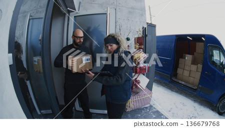 Female Courier With Headset Carries Parcel Front Door Female Courier With Headset Carries Parcel Front Door 136679768
