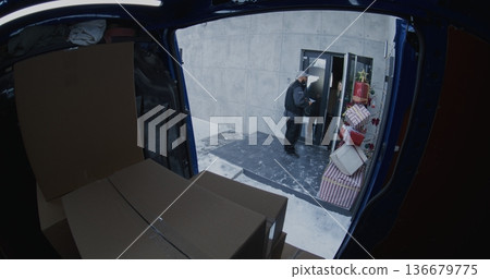 Professional Courier Retrieves Cardboard Boxes From Blue Delivery Van Professional Courier Retrieves Cardboard Boxes From Blue Delivery Van 136679775