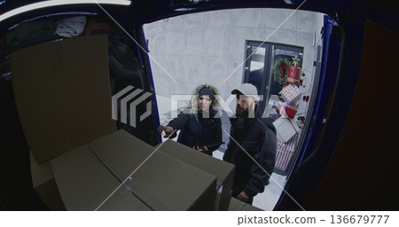 Courier Uses Handheld Scanner to Process Cardboard Boxes Inside Delivery Van Courier Uses Handheld Scanner to Process Cardboard Boxes Inside Delivery Van 136679777