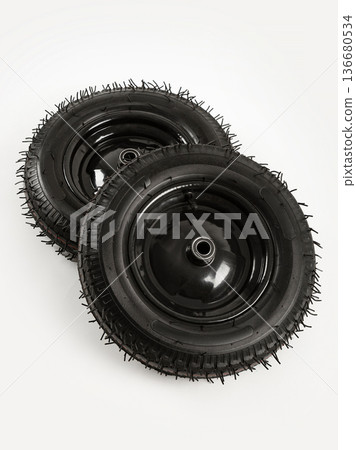 Two wheels from a garden cart on a white background. Black rubber and disc. Two wheels from a garden cart on a white background. Black rubber and disc. 136680534