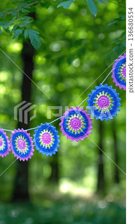 Bright Crochet Garland Hangs Between Trees in a Forest During Daylight 136680554
