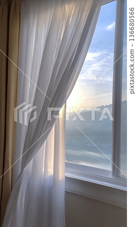 Curtains Move Gently in the Morning Breeze as Sunlight Streams Through the Window Curtains Move Gently in the Morning Breeze as Sunlight Streams Through the Window 136680566