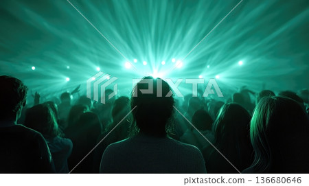 Dynamic Crowd Dancing Together in a Venue With Green Lights During an Exciting Event 136680646