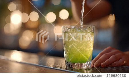 Bartender Pours a Green Drink Into a Glass Under Cinematic Bar Lighting in a Lively Setting Bartender Pours a Green Drink Into a Glass Under Cinematic Bar Lighting in a Lively Setting 136680688