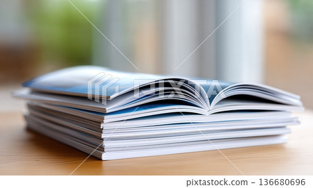 Many Magazines Stacked on a Wooden Table at a Cozy Indoor Space for Reading and Leisure Many Magazines Stacked on a Wooden Table at a Cozy Indoor Space for Reading and Leisure 136680696