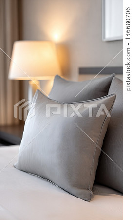 Soft Premium Pillows Placed on a Bed With a Warm Lamp in a Modern Hotel Room Setting at Night 136680706