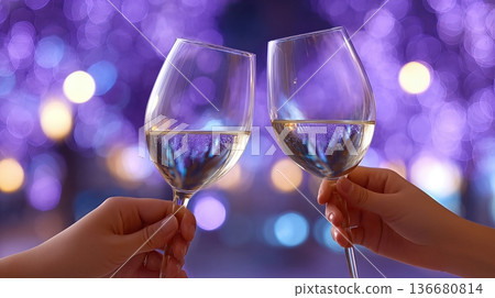 Hands Hold Drinking Glasses in a Festive Setting With Colorful Lights in the Background Hands Hold Drinking Glasses in a Festive Setting With Colorful Lights in the Background 136680814