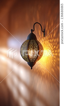 Closeup View of Traditional Lantern Casting Light Patterns on the Wall in a Warm Space 136680865
