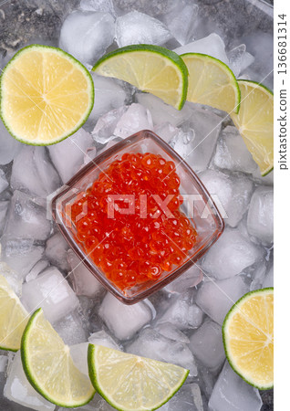 fresh red  salmon caviar with lime around ice. macro shot.  Protein luxury delicacy  healthy food. close up. flat lay 136681314