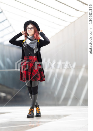 Young woman confidently posing urban modern background Young woman confidently posing urban modern background 136681356
