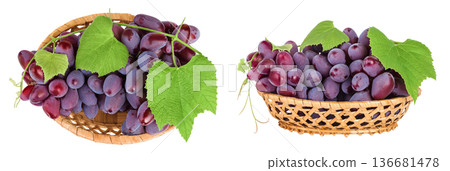 Red grape berry bunch in a wicker basket isolated on white background. Top view. Flat lay Red grape berry bunch in a wicker basket isolated on white background. Top view. Flat lay 136681478