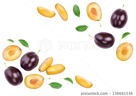 fresh purple plum and half with leaves isolated on white background with copy spase for your text. Top view. Flat lay fresh purple plum and half with leaves isolated on white background with copy spase for your text. Top view. Flat lay 136681536
