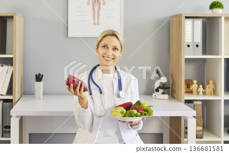 Female nutritionist doctor with stethoscope promoting health and fresh vegetables 136681581