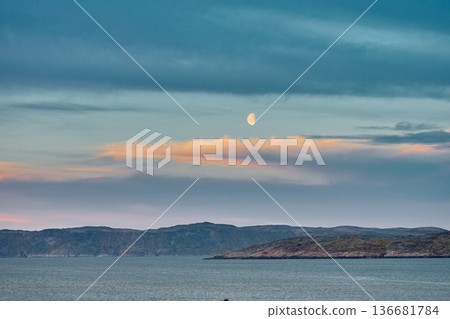 Weathered wooden houses in Teriberka at dusk, Russia, Kola Peninsula, evoke a bygone era, standing as silent witnesses to the passage of time. Teriberka's historical architecture concept Weathered wooden houses in Teriberka at dusk, Russia, Kola Peninsula, evoke a bygone era, standing as silent witnesses to the passage of time. Teriberka's historical architecture concept 136681784