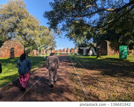 Misiones, San Ignacio, Argentina - June 23, 2025: Tourists visit the ruins of the Jesuit mission of San Ignacio Mini do Guaranisi. UNESCO World Heritage Site, South America. Misiones, San Ignacio, Argentina - June 23, 2025: Tourists visit the ruins of the Jesuit mission of San Ignacio Mini do Guaranisi. UNESCO World Heritage Site, South America. 136681842