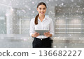 Smiling professional woman holding a digital tablet for banking, budget planning and financial apps. 136682227