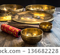 Tibetan singing bowls and a gong on a wooden table for sound healing, meditation, and spiritual zen. 136682228